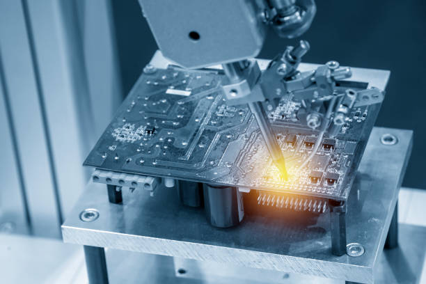 istock The soldering robot welding the circuit board. 1054727154