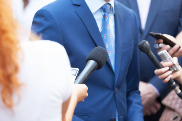 istock Journalists making media interview with unrecognizable business person or politician 1054727408