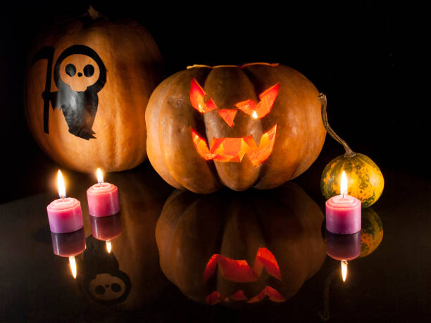 istock Halloween carved pumpkin and candle on black background 1054735084