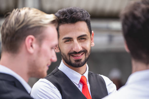 istock businessman hispanic smile looking camera when talking with partner happy smiling positive business worker concept. 1054744676