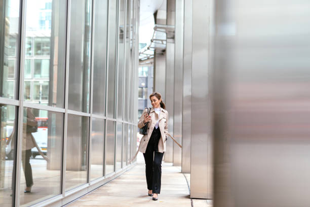 istock Successful businesswoman in financial district using phone 1054744856
