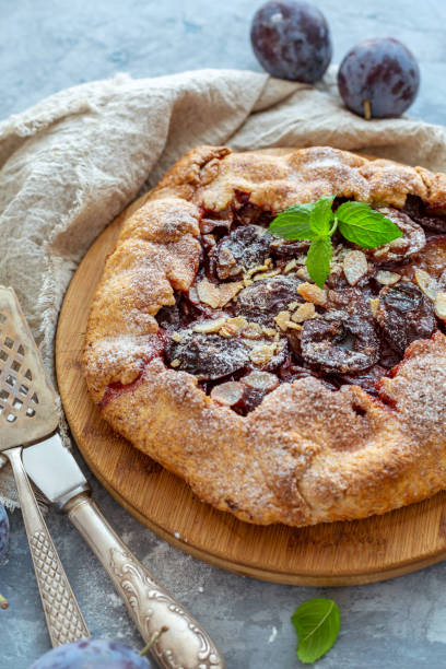 istock Homemade plum pie with a sprig of mint. 1054745182