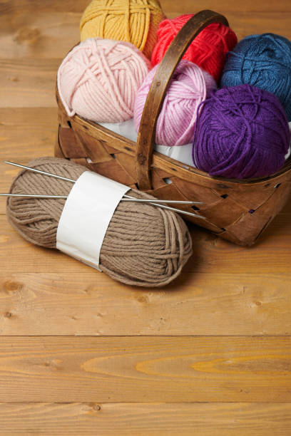 istock colorful wool threads for knitting on wooden background 1054747944