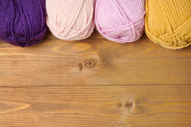 istock colorful wool threads for knitting on wooden background 1054748682