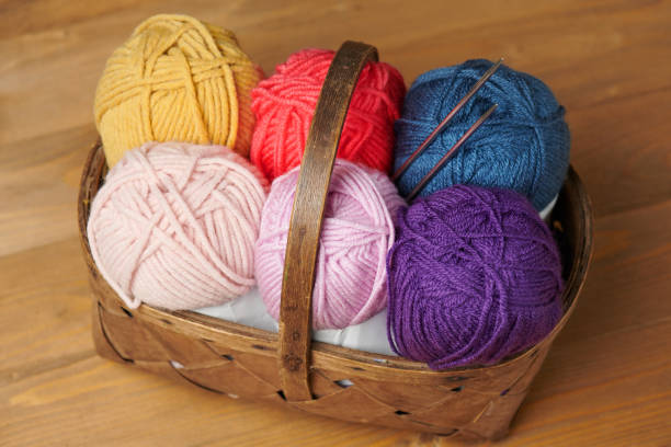 istock colorful wool threads for knitting on wooden background 1054748732