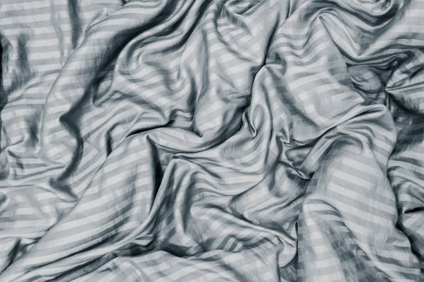 istock blanket wrinkled on the bed in bedroom. 1054750592