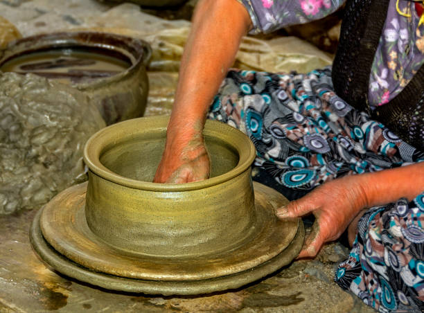 earth pots making The pottery, which is unique to the Gökeyüp region, starts with the men taking the Gnays rock to their homes with tractors. finger spinning globe stock pictures, royalty-free photos & images