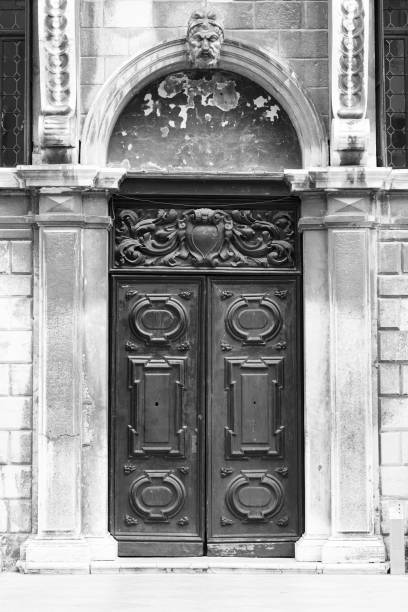 istock old and black wooden door 1054754104