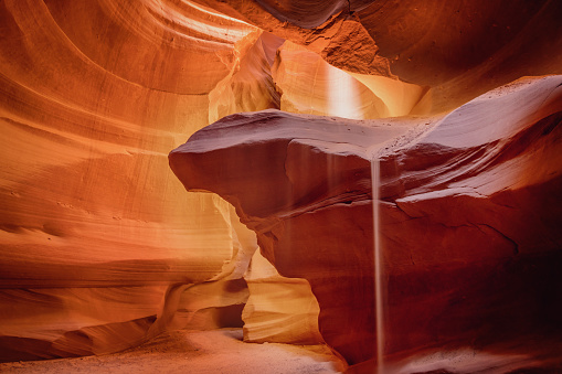 Little Sand Fall inside beautiful Antelope Canyon in early morning light. Long time Exposure. Motion Blured Sand Fall in the Canyon. Page, Arizona, USA