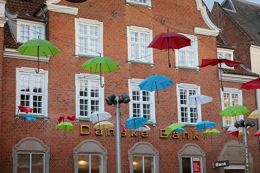 Vestergade, Viborg, Denmark - August 10, 2018: Main Street is a kind of outdoor shopping centre, a place with shops and restaurants and to create a positive mood, the street is decorated with umbrellas in front of a bank, called Danske Bank