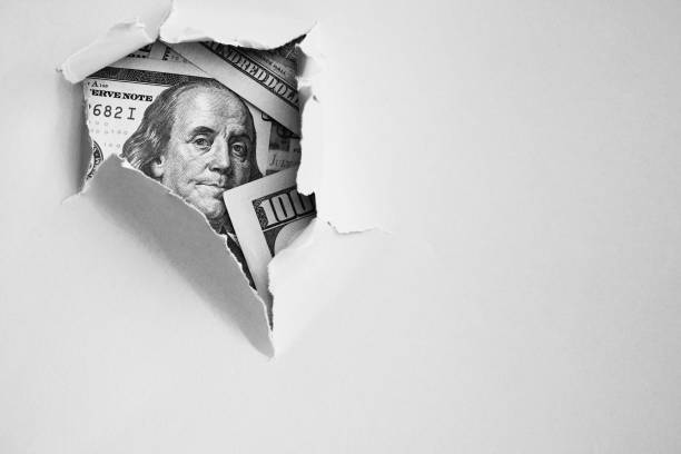 istock Money under holed paper 1054765878