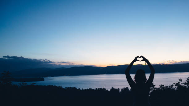 Heart Shape with Hands Female Hiker Watching Sunset Over Lake