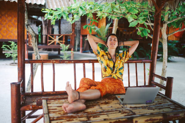 Young woman doing her freelance work outdoors in Thailand