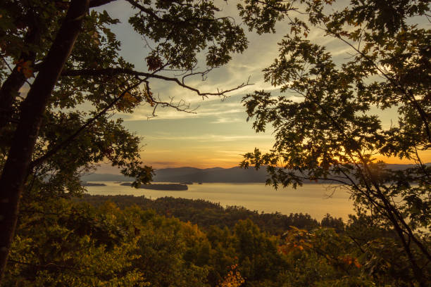 istock Tranquil Sunset Tree Silhouettes over Lake George, Adirondack Mountains, New York 1054781082