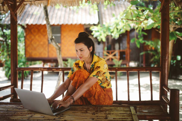 istock Young woman doing her freelance work outdoors in Thailand 1054781318