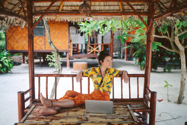 istock Young woman doing her freelance work outdoors in Thailand 1054784768