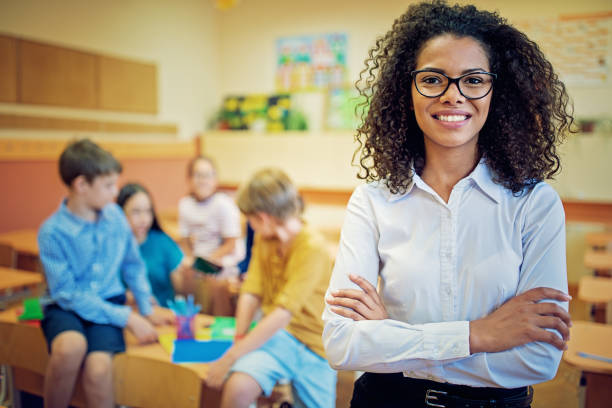 istock Portrait of teacher in the classroom 1054784872