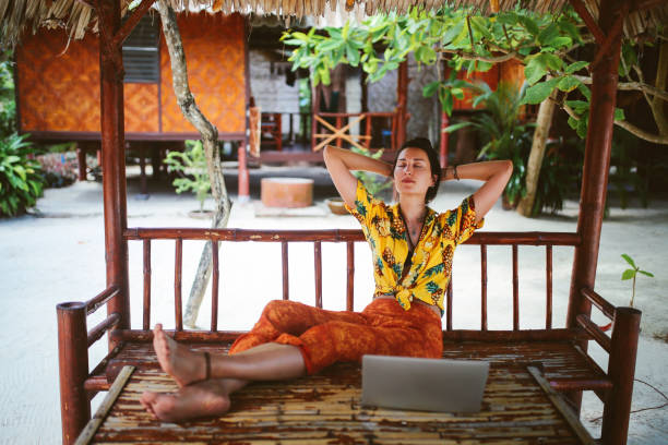 istock Young woman doing her freelance work outdoors in Thailand 1054785618