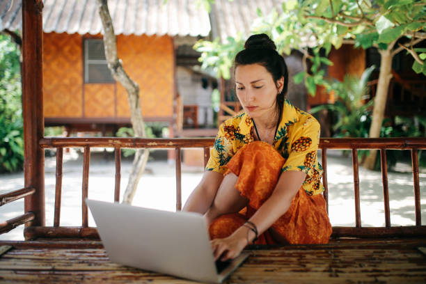 istock Young woman doing her freelance work outdoors in Thailand 1054785706