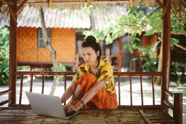 istock Young woman doing her freelance work outdoors in Thailand 1054786846