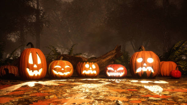 istock Carved halloween pumpkins in autumn forest at dusk 1054787270
