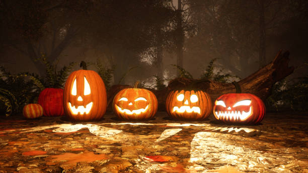 istock Jack-o-lantern halloween pumpkins in foggy forest 1054787438