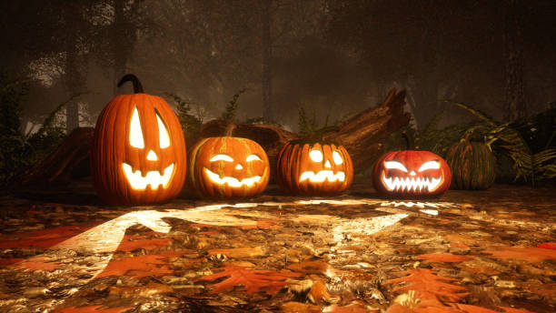 istock Jack-o-lantern pumpkins in misty autumn forest 1054787530