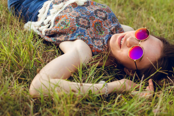 istock Young woman lying on grass 1054787726