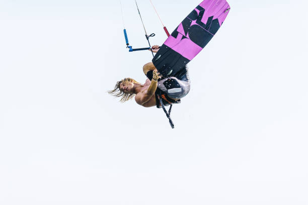 Young man jumping with kiteboard against the sky. Copy space.