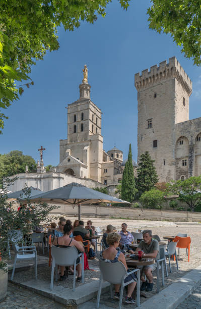 France. Avignon. July 2nd, 2018. Tourists sitting in an outdoor restaurant under the Popes Palace
