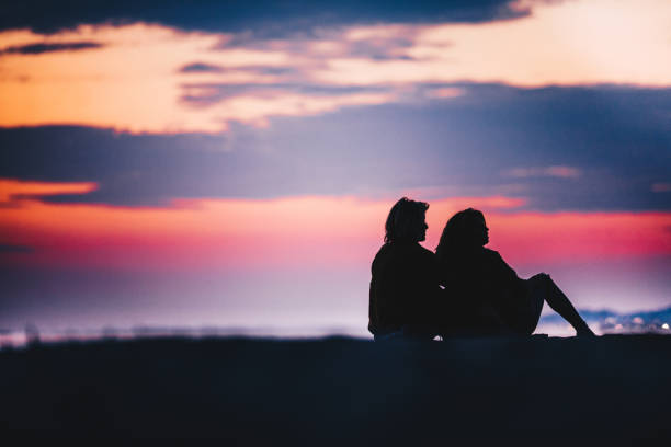 istock Silhouette of a relaxed couple at dusk. 1054789578