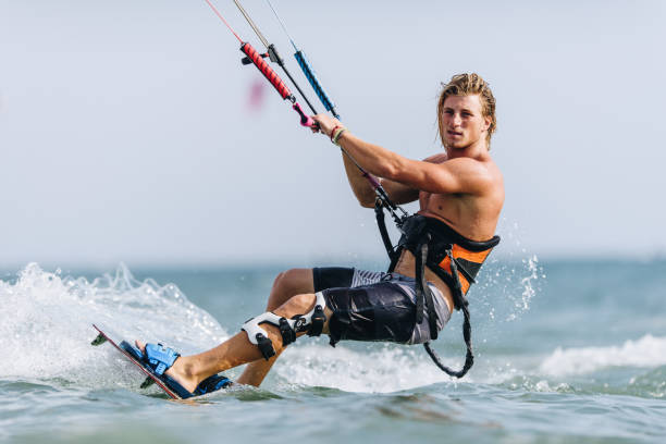 istock Young man enjoying in kiteboarding during summer day at sea. 1054792330