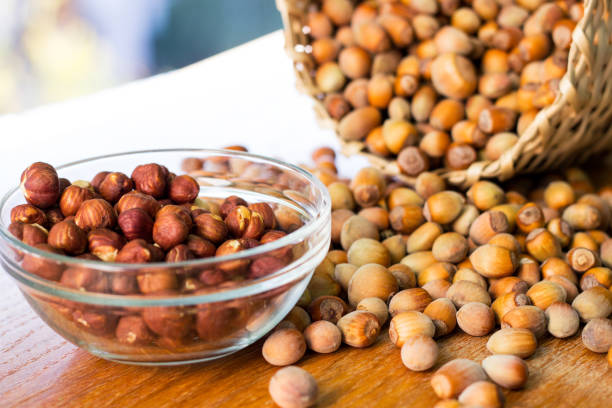istock Hazelnuts in a wicker basket on old wooden table 1054793748