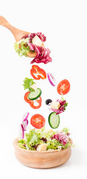 istock Wooden dishes with salad on a white background. 1054793870