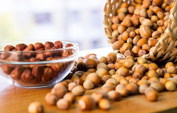 istock Hazelnuts in a wicker basket on old wooden table 1054793978