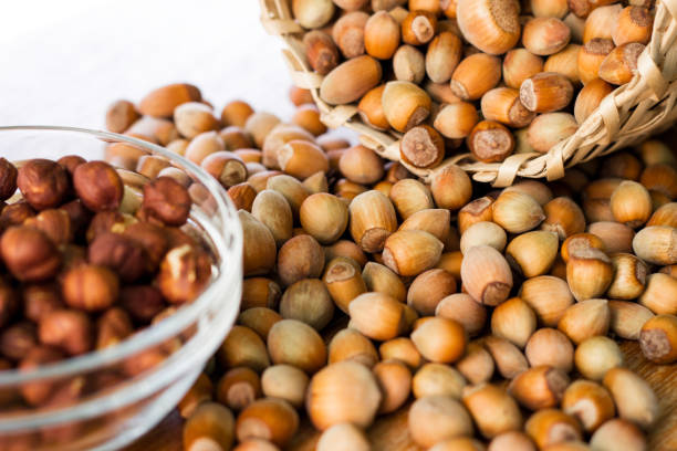 istock Hazelnuts in a wicker basket on old wooden table 1054794406