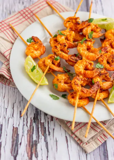 Grilled Shrimp / Prawn in the Skewers Served on a White Plate