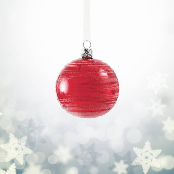 istock Glass Red Christmas Ornament over Snowflake Background 1054796674