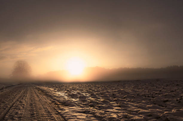 istock Winter road covered with snow at sunrise 1054802640