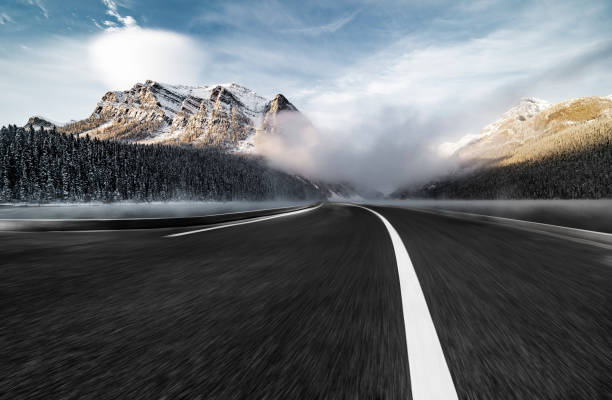 istock road towards snow-capped mountain 1054802660