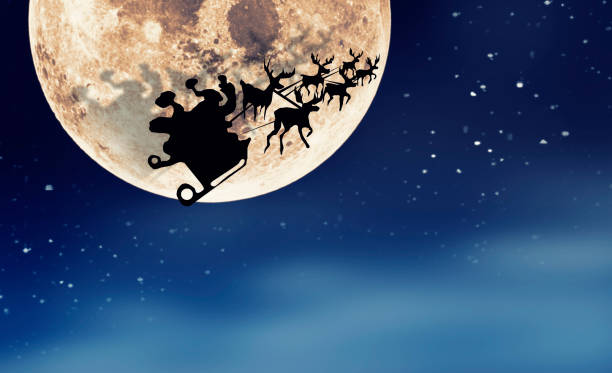 istock Santa Claus Sleight and Reindeers Silhouette Flying over the Moon 1054805322