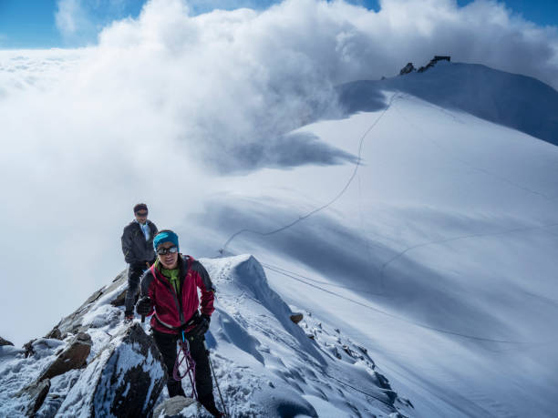 istock Climbers couple on a snowy ridge. 1054812430