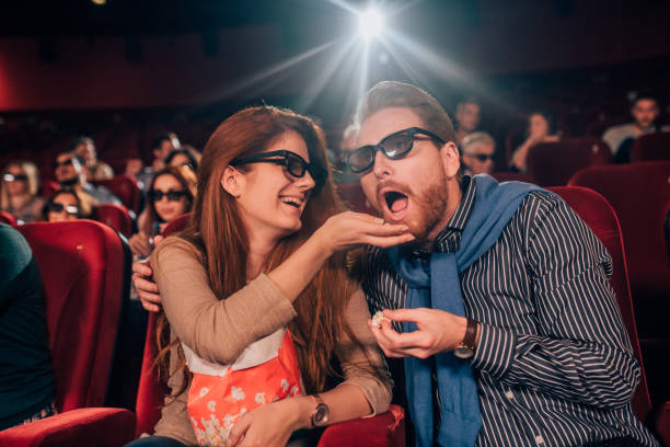 istock Man eating popcorn from his girlfriend's hand 1054821630
