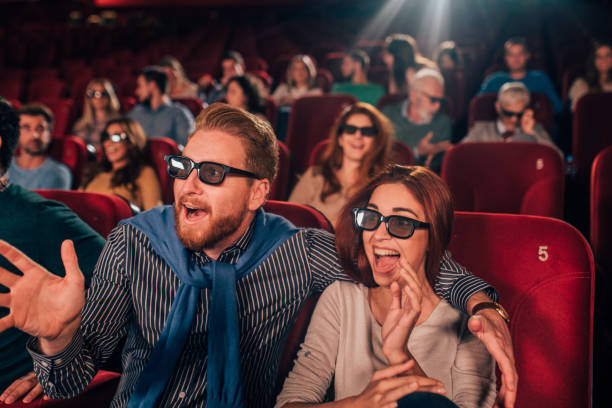 istock Happy couple with 3D glasses at cinema 1054821640