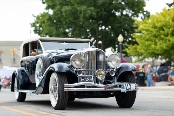Vintage Elegance: Detailed View of a Classic Car's Chrome Headlight and Iconic Grille - Preserving Automotive History