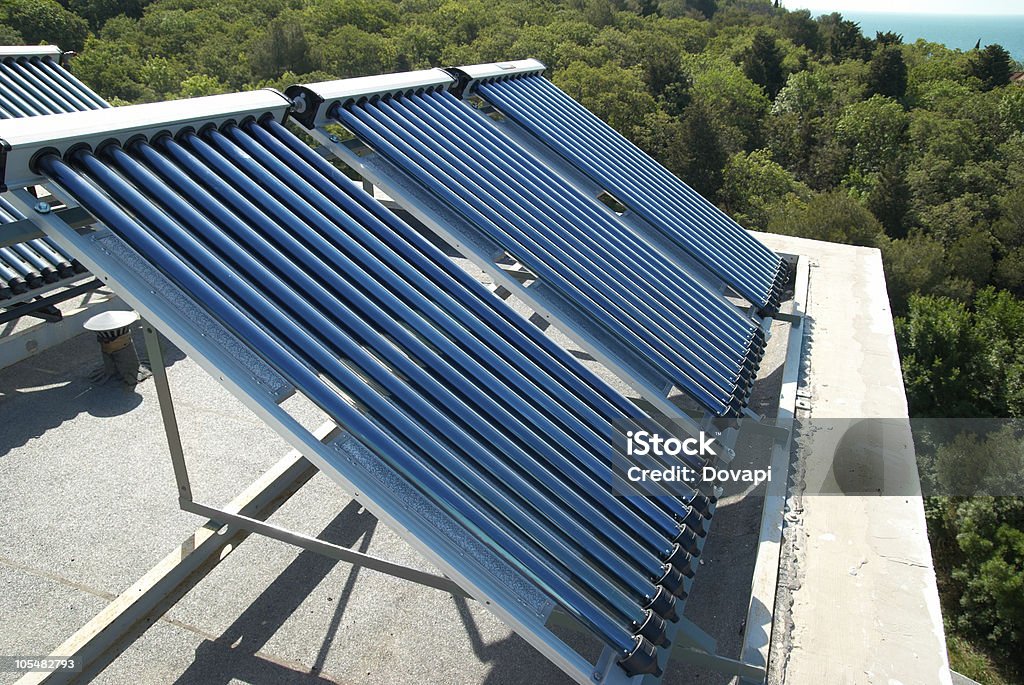 Vacuum solar heating system on the roof of a house Vacuum solar water heating system on the house roof. Airtight Stock Photo