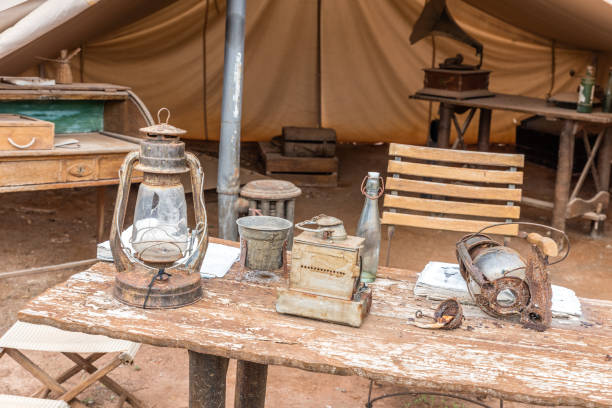 camping tent, old wooden table with explorer utensils