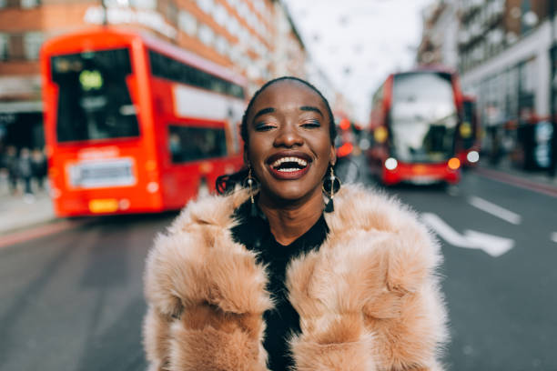 Portrait of modern black woman in Oxford Street in London, UK City break in London with loved ones is always an option for quick getaway. inner london stock pictures, royalty-free photos & images