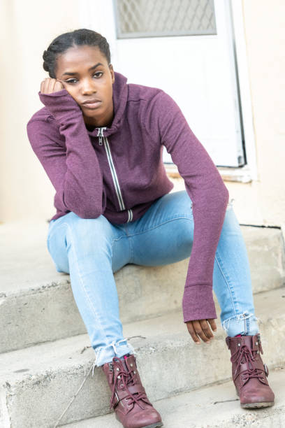 istock Serious bored beautiful young black woman 1054840896