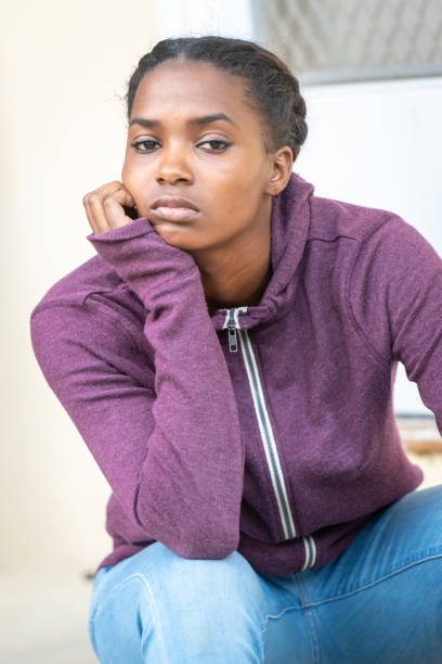 istock Serious bored beautiful young black woman 1054841288